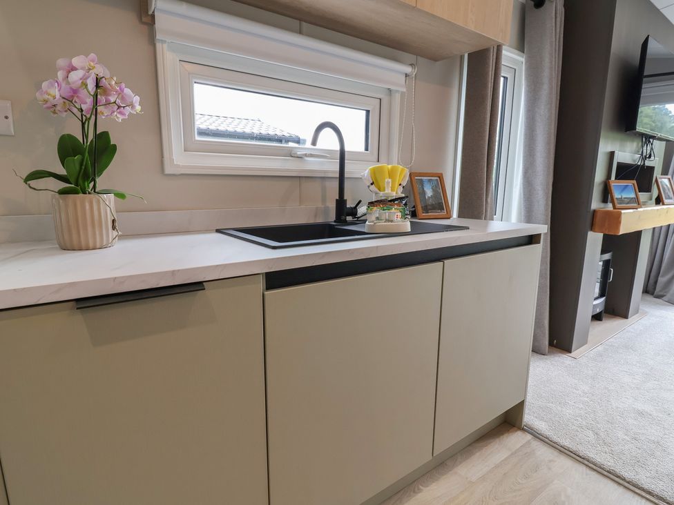 A kitchen with a sink and a window at The Pines 3 Bedrooms in Delamere
