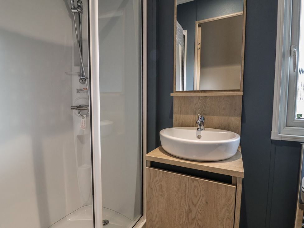A bathroom with a shower and a sink at The Pines 3 Bedrooms Delamere
