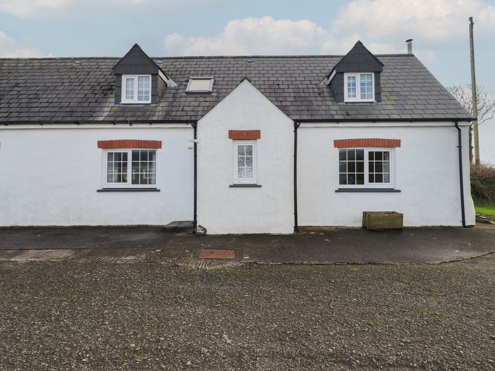 A cottage with windows and a driveway at Rhosgranog Cottage Llandeloy near Solva
