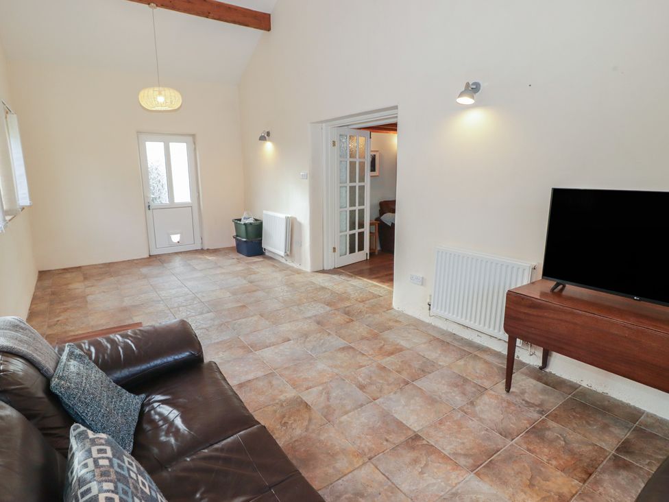 A living room with a sofa and television at Rhosgranog Cottage Llandeloy near Solva