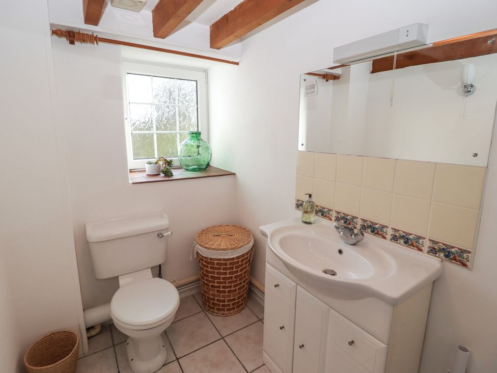 A bathroom with a sink and toilet at Rhosgranog Cottage in Llandeloy near Solva