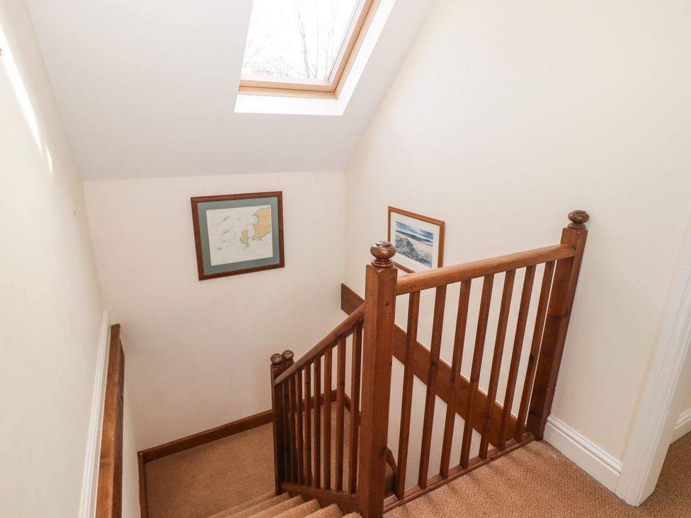 A staircase with framed pictures and a skylight at Rhosgranog Cottage Llandeloy near Solva