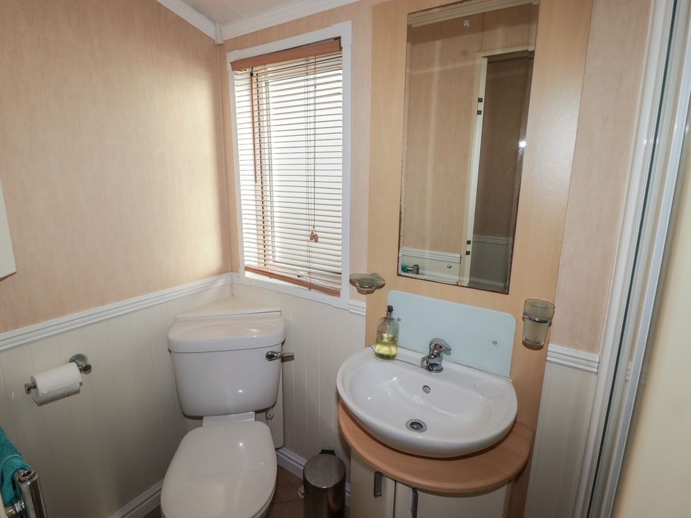A bathroom with a sink and toilet at Rhosgranog Caravan in Llandeloy near Solva