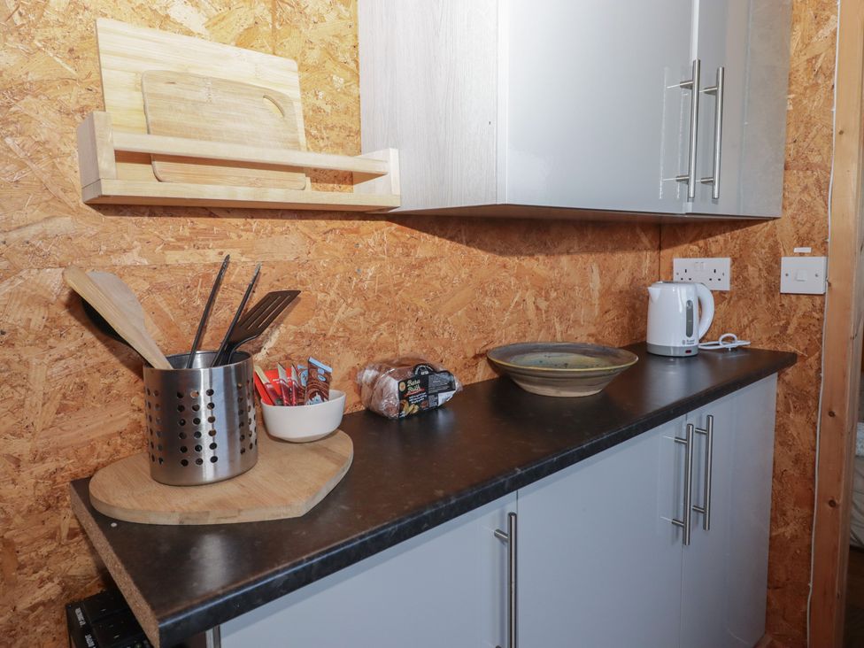 A kitchen with utensils and appliances at Rhosgranog Shepherds Hut Llandeloy near Solva