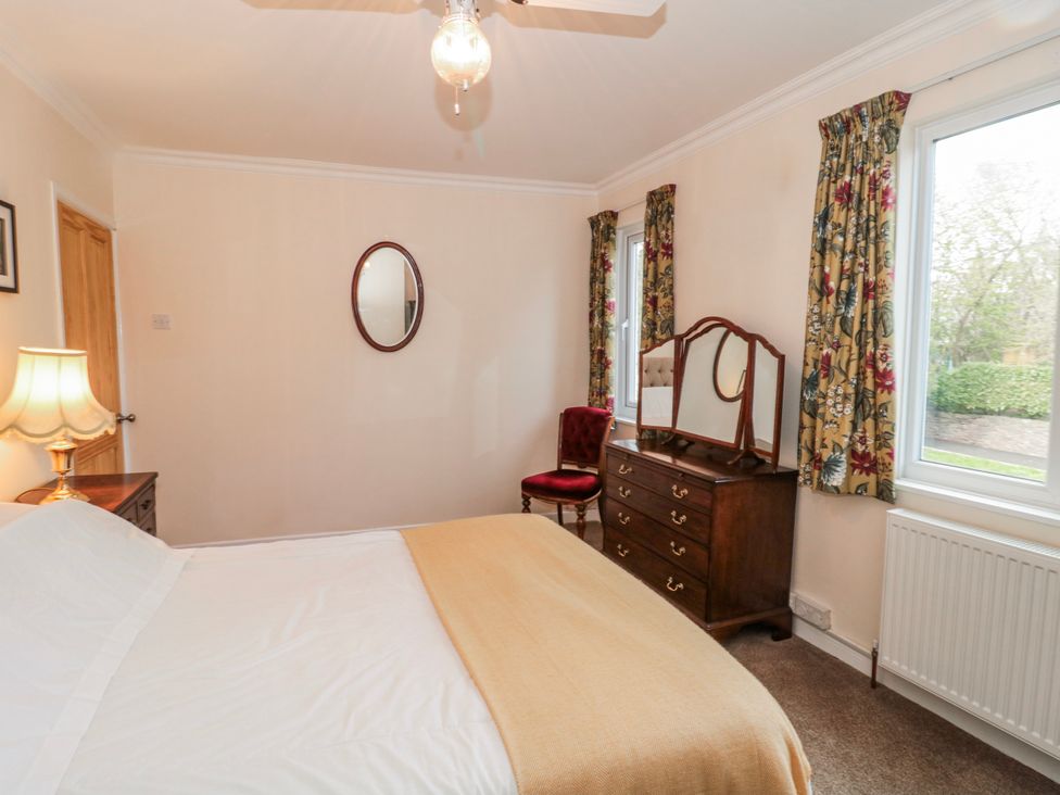A bedroom with a bed and dresser at The Flat House in Taunton