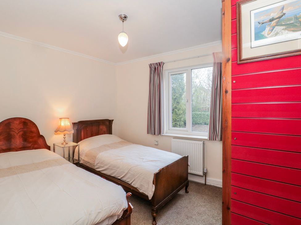 A bedroom with two beds and a window at The Flat House in Taunton