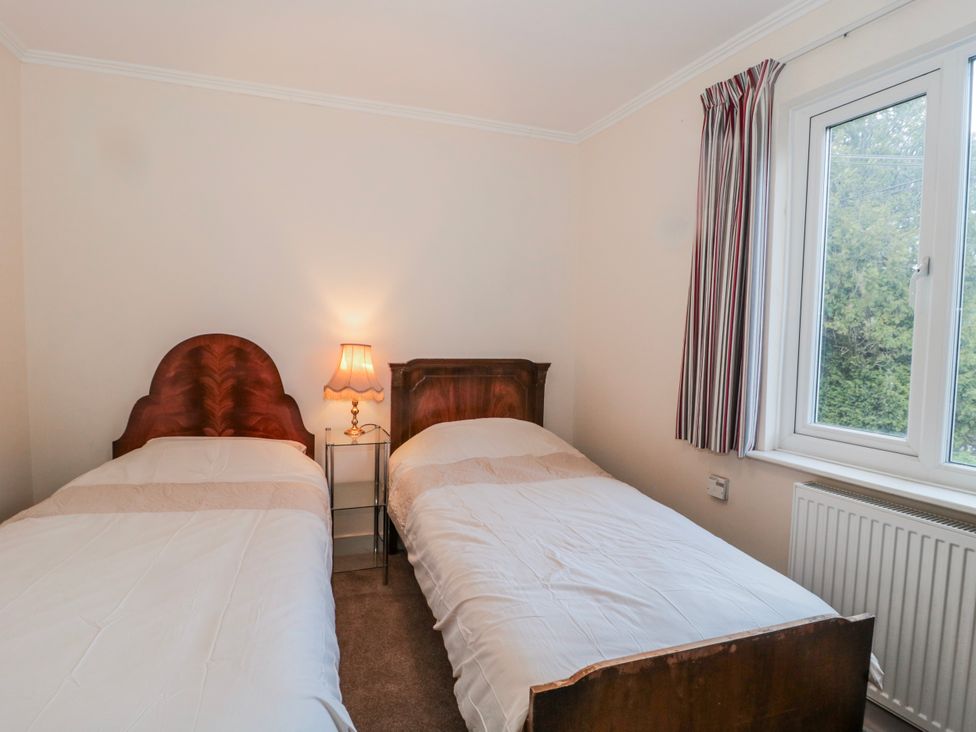 A bedroom with two beds and a lamp at The Flat House in Taunton