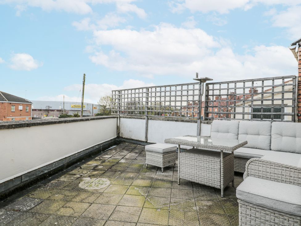 A terrace with outdoor furniture and table at The Flat House in Taunton