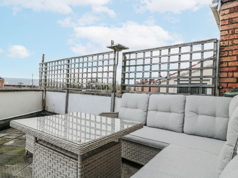 A balcony with a sofa and table at The Flat House in Taunton