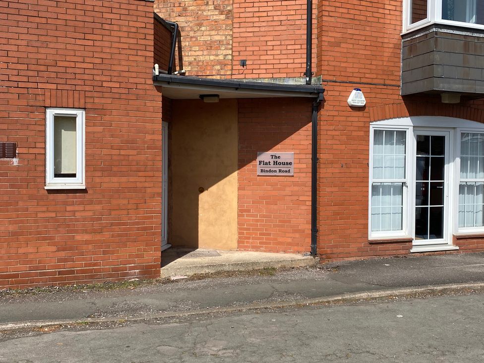 An entrance with a nameplate at The Flat House Bindon Road