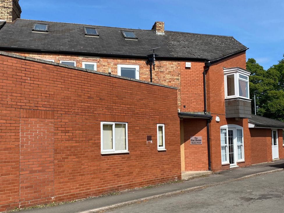 An exterior view of a brick building with windows and a door at The Flat House in Taunton