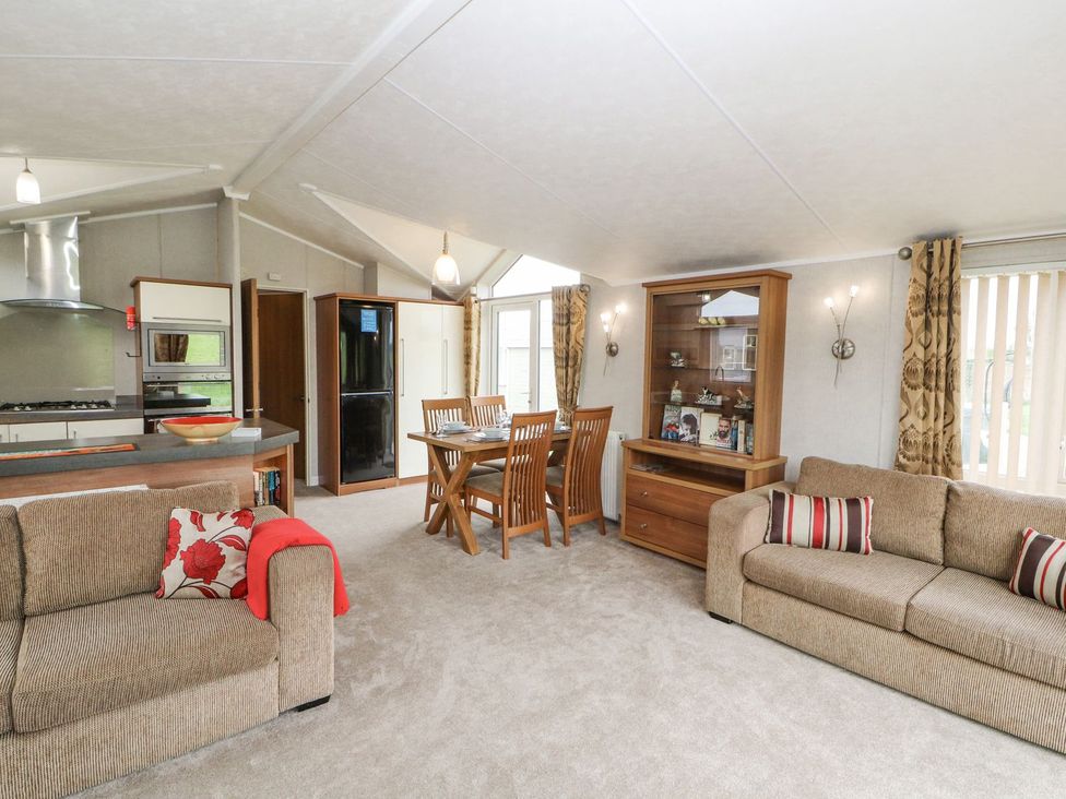 A living room and kitchen area at No 8 Hillcote Lodge in Cockermouth
