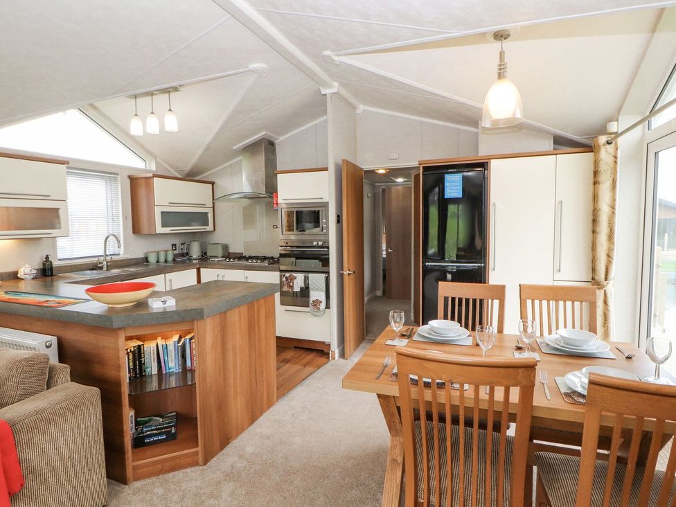 A kitchen with dining table and chairs at No 8 Hillcote Lodge in Cockermouth