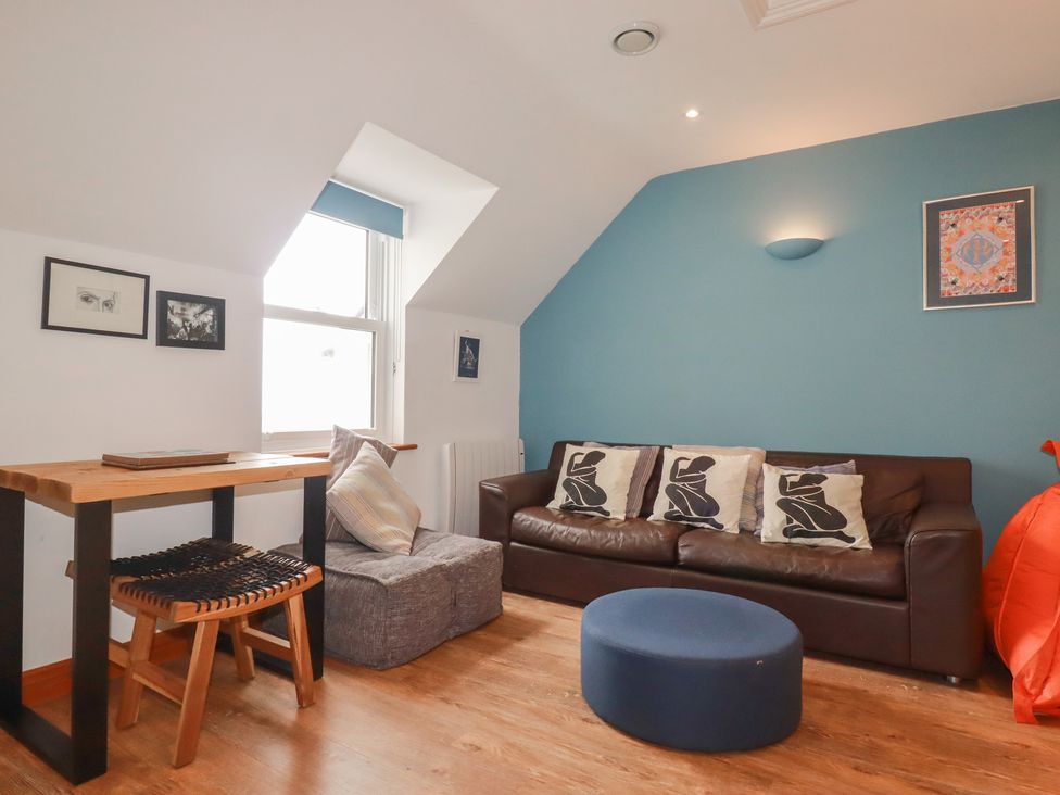 A living room with a sofa and table at Beachcombers Apt 11