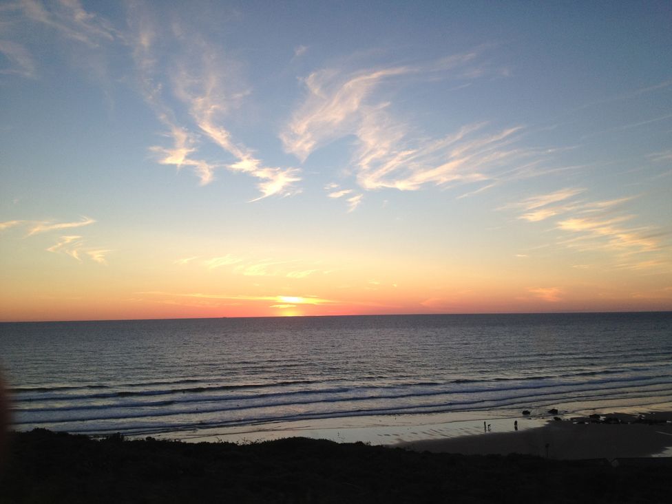 A beach scene during sunset at Beachcombers Apt 11 Watergate Bay near Newquay