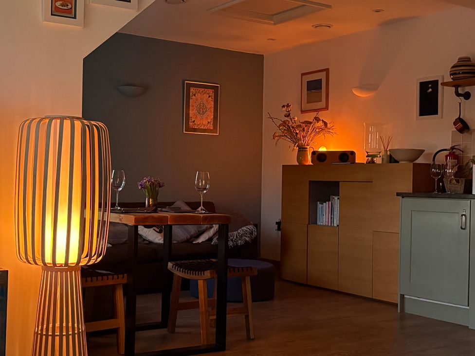 A dining room with a table and wine glasses at Lowenna Watergate Bay near Newquay