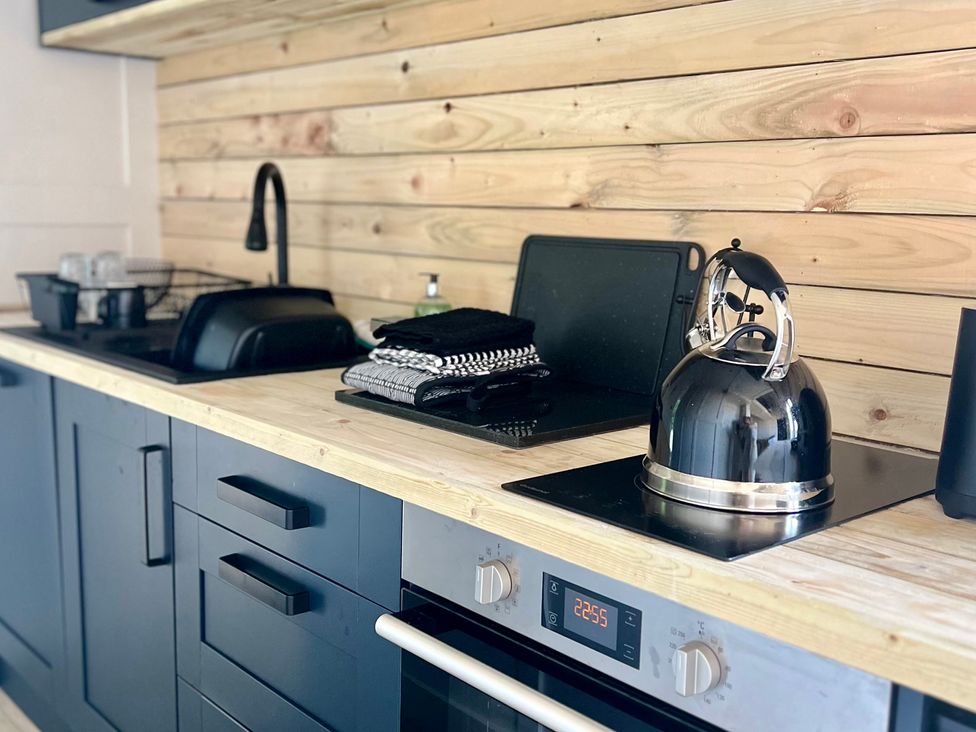 A kitchen with a kettle and sink at Rustwood Manor in Minety