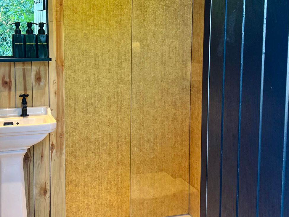 A bathroom with a sink and a shower at Rustwood Manor Minety