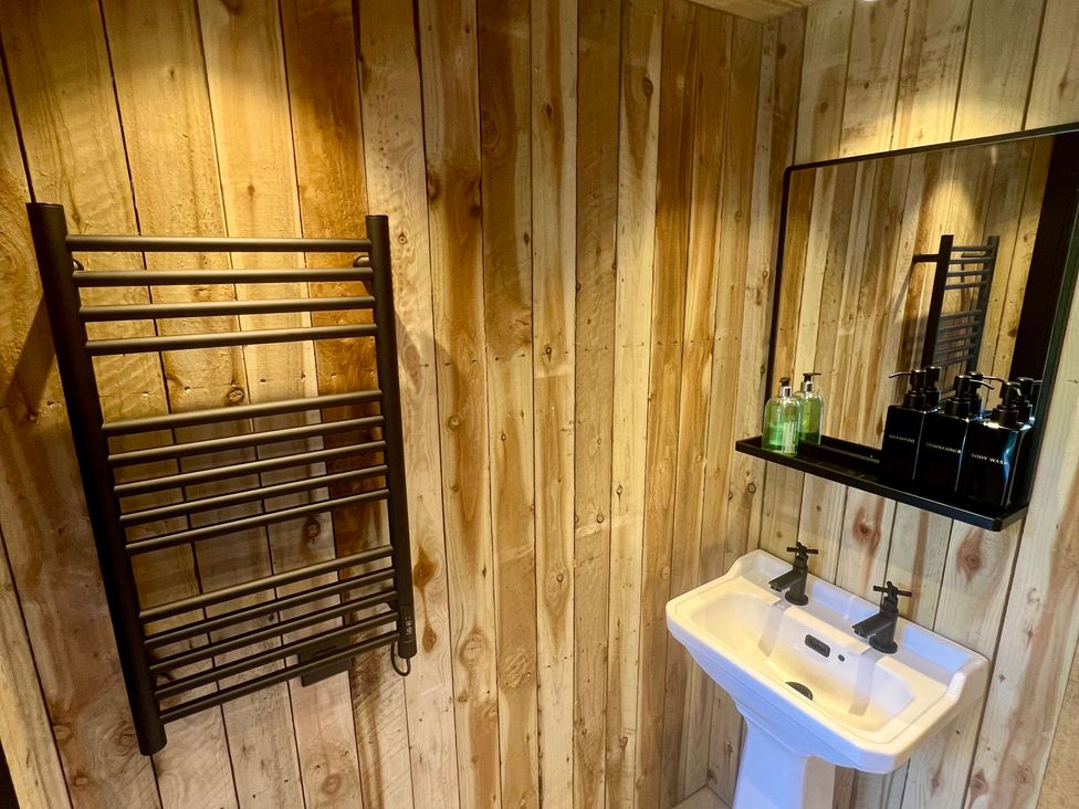 A bathroom with a sink and towel radiator at Rustwood Manor Minety