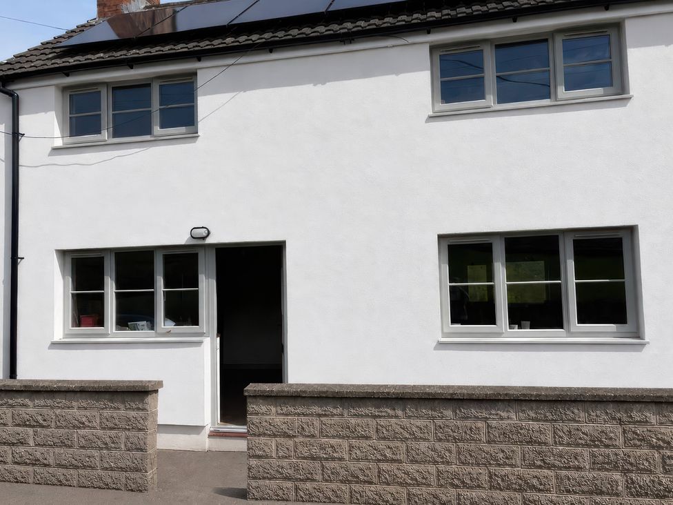 An exterior view of a house with windows and a door at Araelfa in Llwynmawr