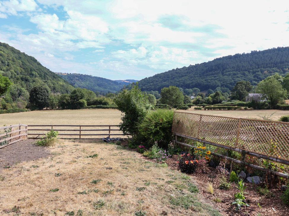 A field with flowers and a fence at Araelfa, Llangollen