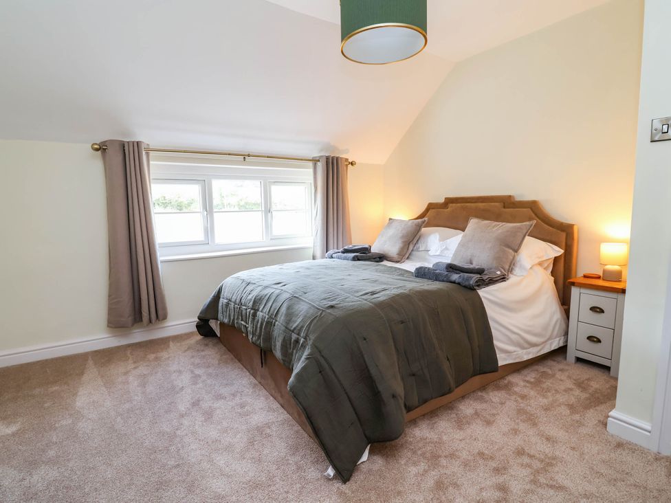 A bedroom with a bed and window at Araelfa Llangollen