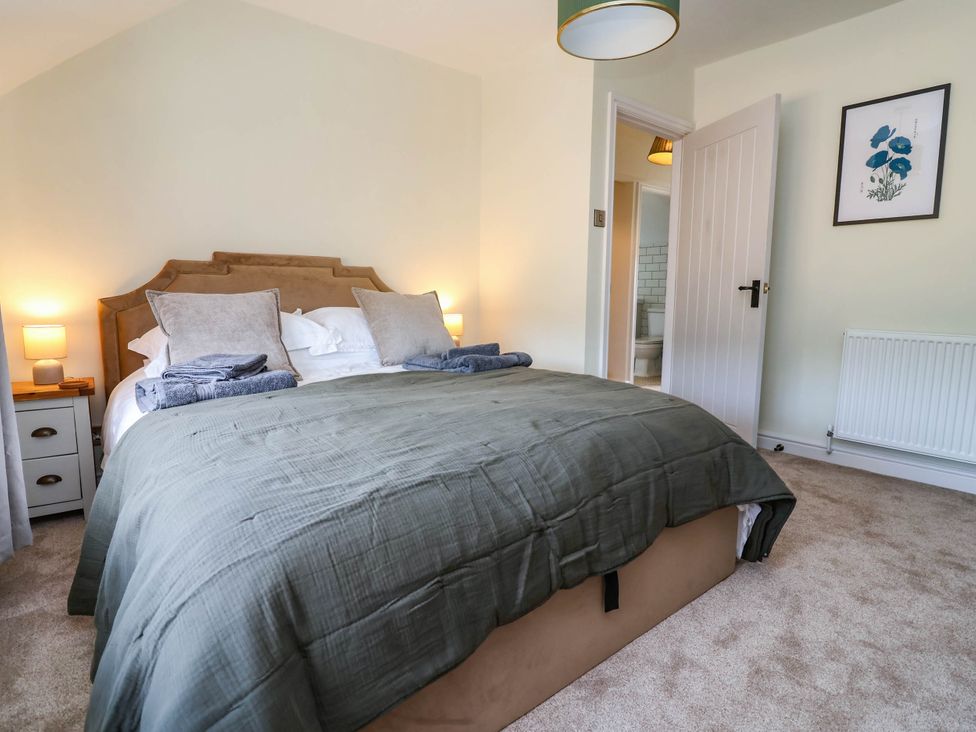 A bedroom with a bed and bedside tables at Araelfa in Llangollen