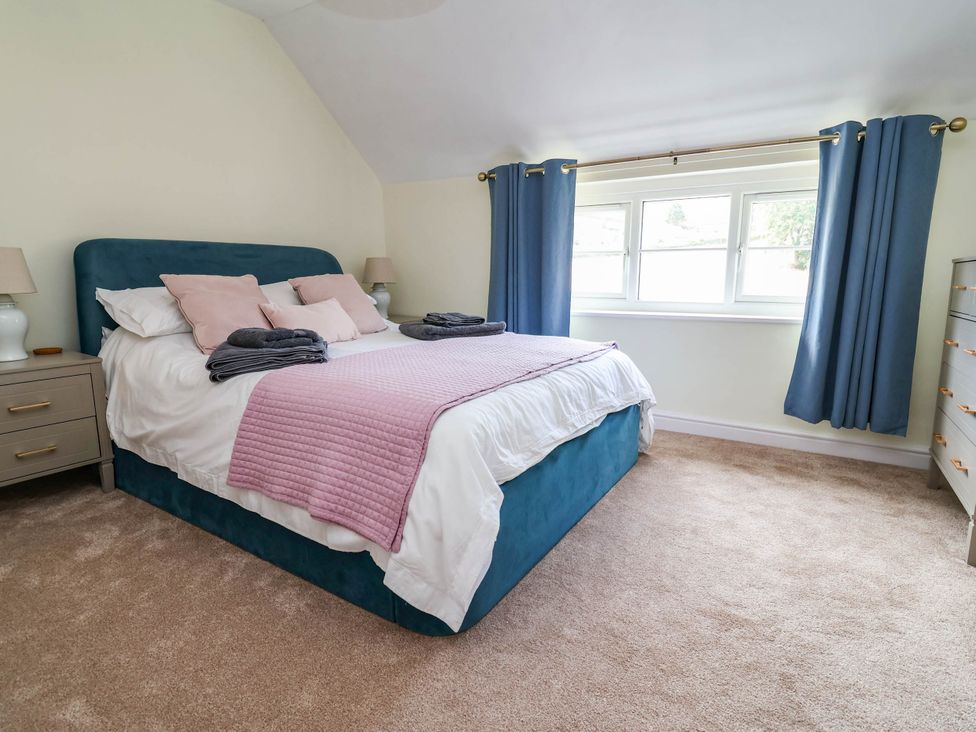 A bedroom with a bed and window at Araelfa in Llangollen