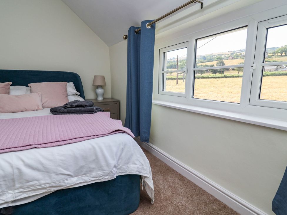 A bedroom with a bed and window at Araelfa in Llangollen