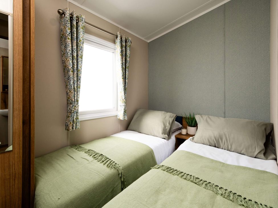 A bedroom with two beds and a window at Ashberry 38 x 12 Two Bed - 1 Delamere