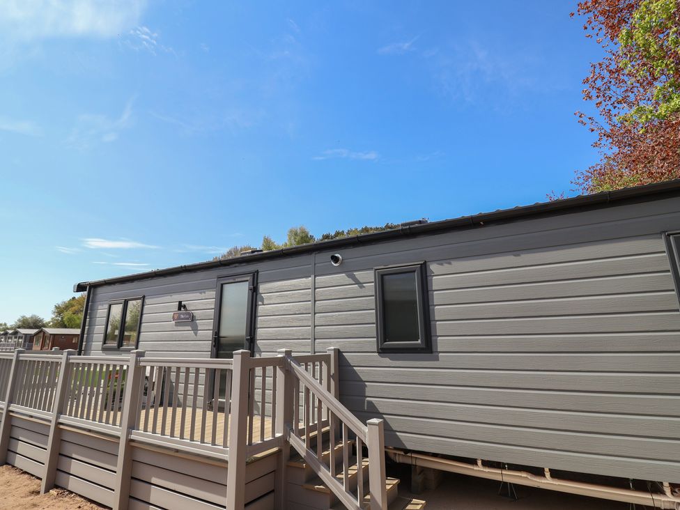 A mobile home with a deck and steps at No.20 - The Oaks Delamere
