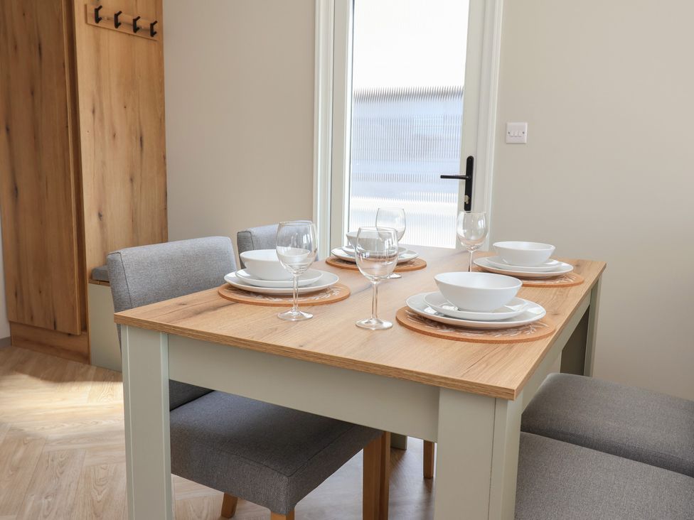 A dining room with a table set for meals at No.20 - The Oaks in Delamere