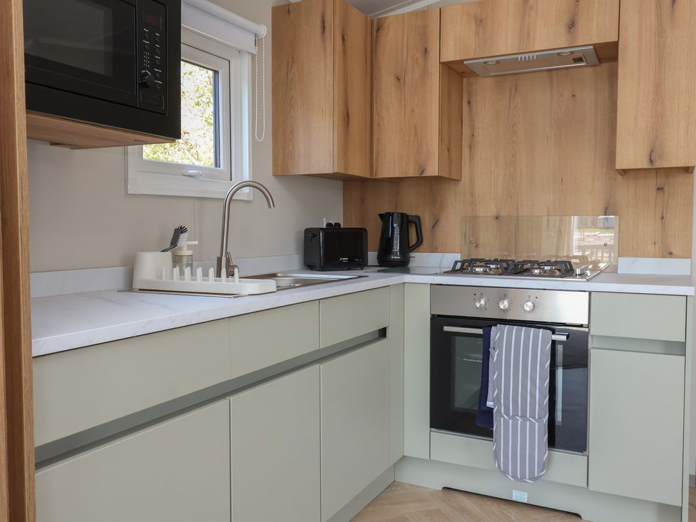 A kitchen with sink and appliances at No.20 - The Oaks Delamere