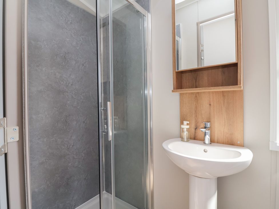 A bathroom with a shower and sink at No.20 - The Oaks, Delamere