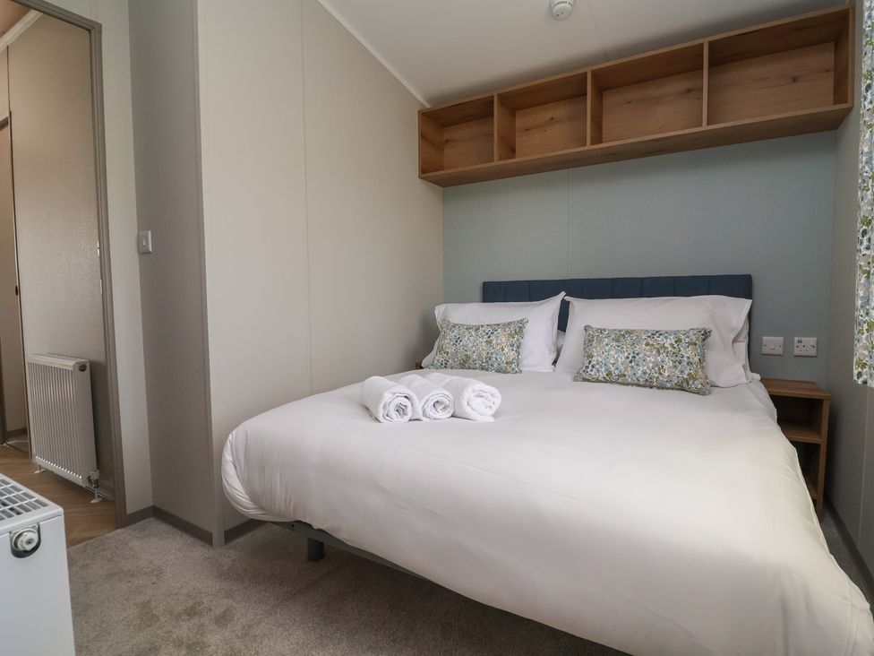A bedroom with a bed and bedside table at No.20 - The Oaks Delamere