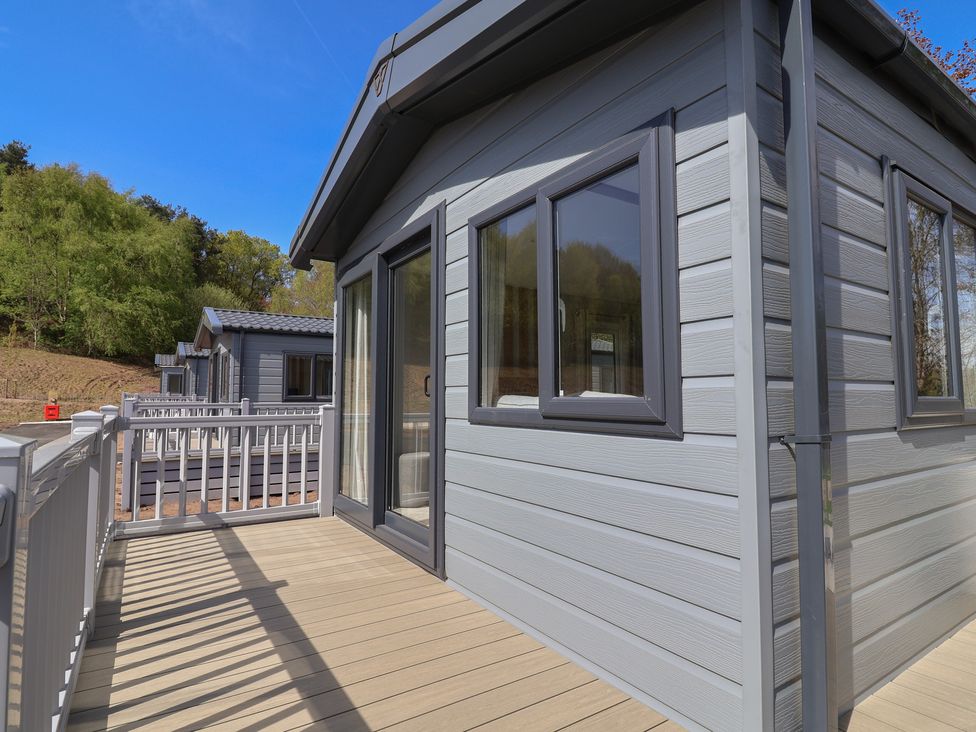 A balcony of a house with windows and wooden deck at No.20 - The Oaks, Delamere