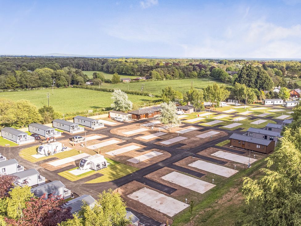 An outdoor view of a caravan park with empty lots at The Oaks 2 Bedrooms Delamere
