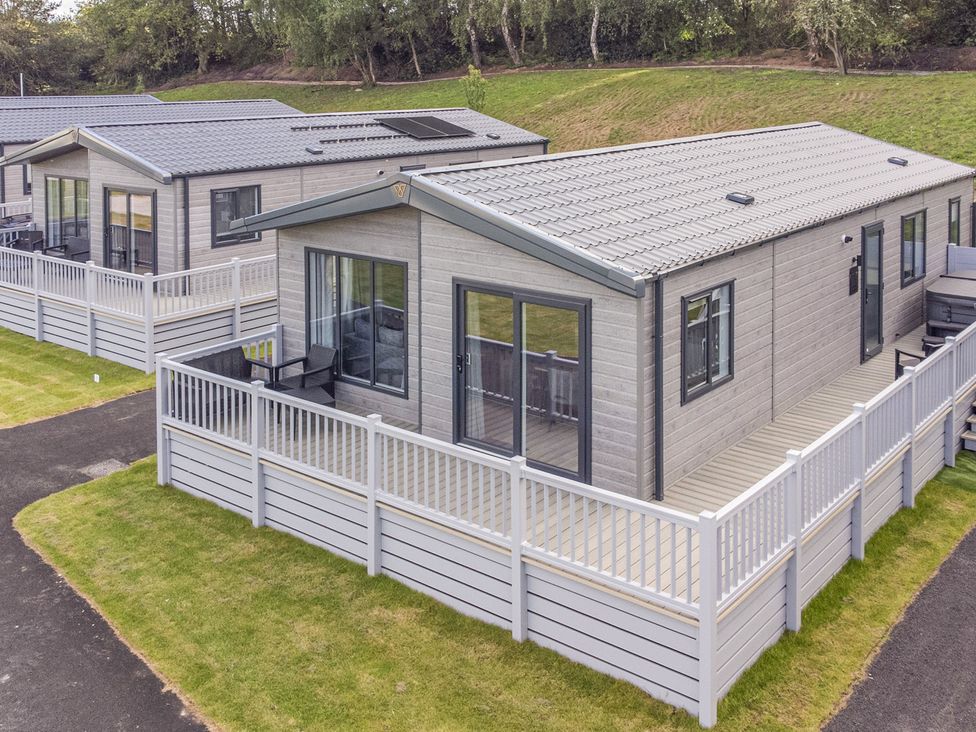 A building with decking and railing at The Oaks 2 Bedrooms in Delamere