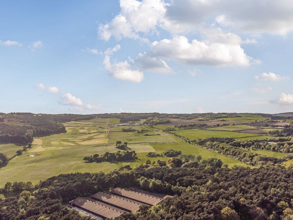 A view of fields and trees with a road and buildings at The Oaks 2 Bedrooms Delamere