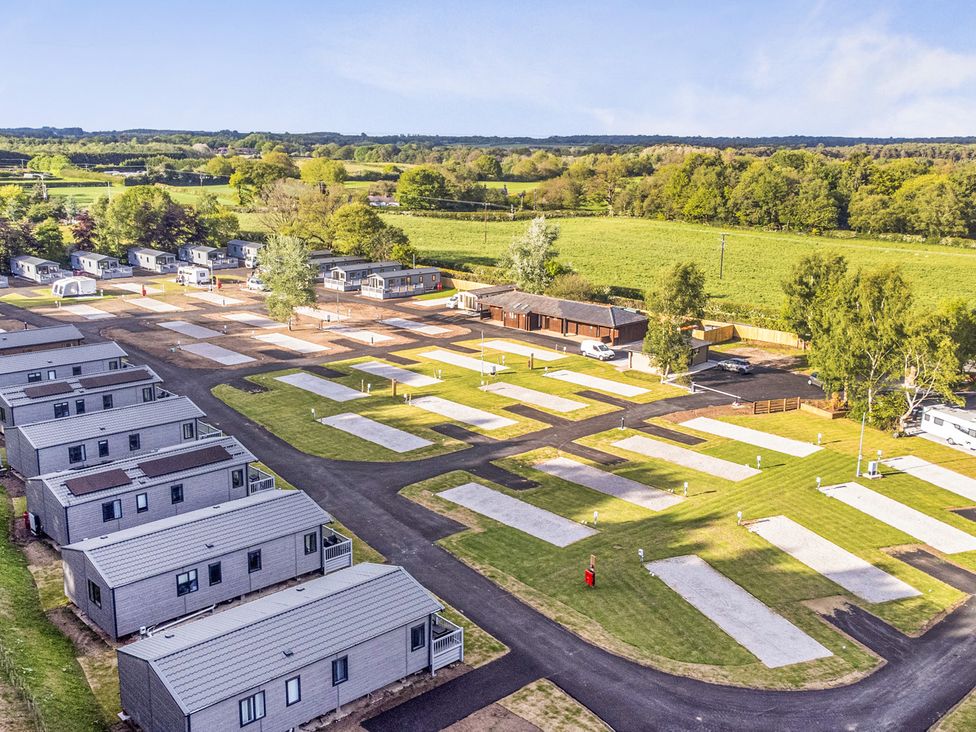 An outdoor area with caravans and grass at The Oaks 2 Bedrooms in Delamere