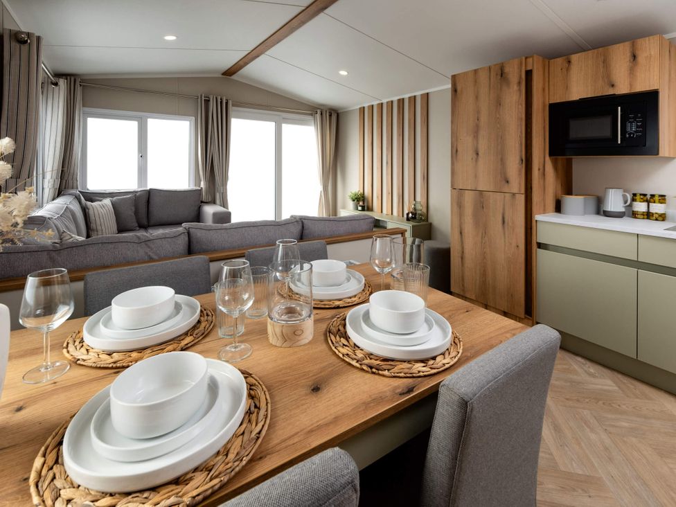 A dining area with a table set for meals at Ashberry 38 x 12 Two Bed (Pet Free) Northwich