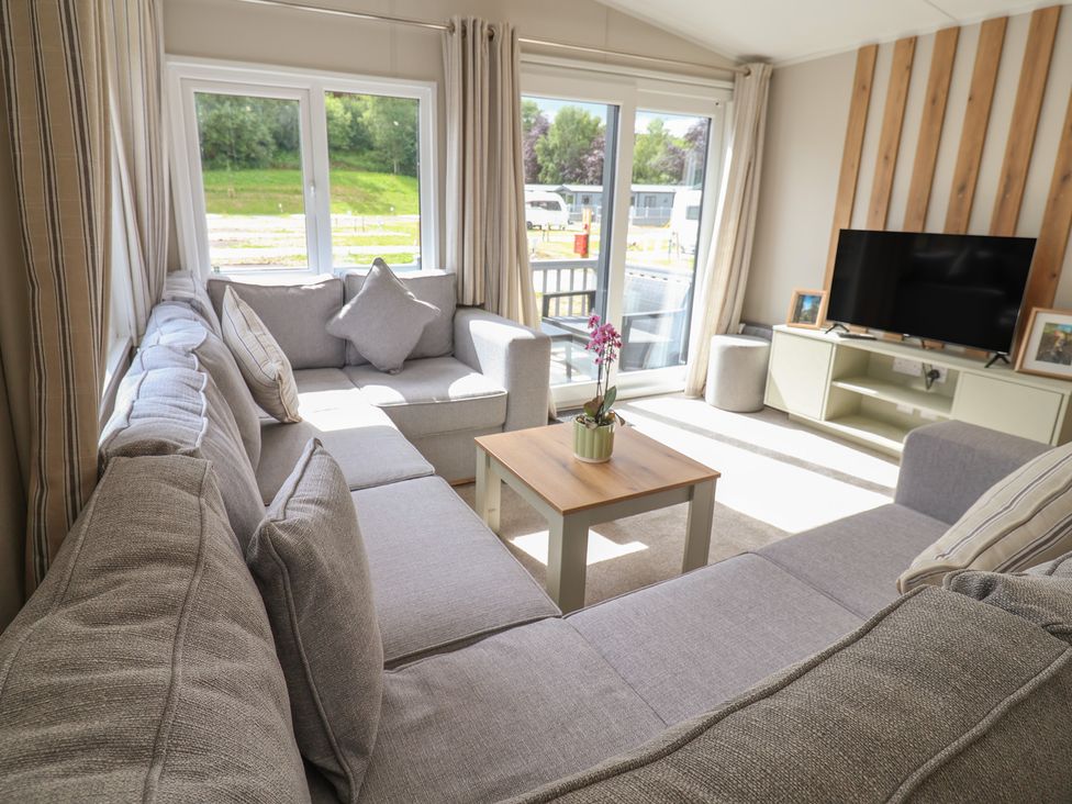 A living room with a sofa and coffee table at The Oaks 2 Bedrooms Delamere