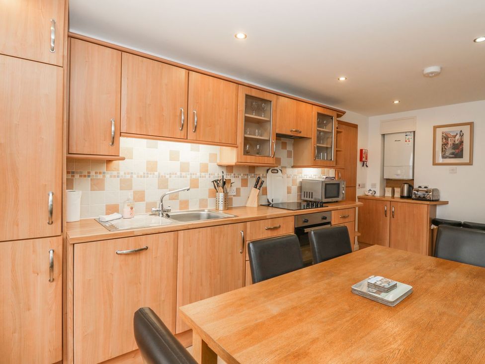 A kitchen with cabinets and appliances at Flour Loft in Anstruther