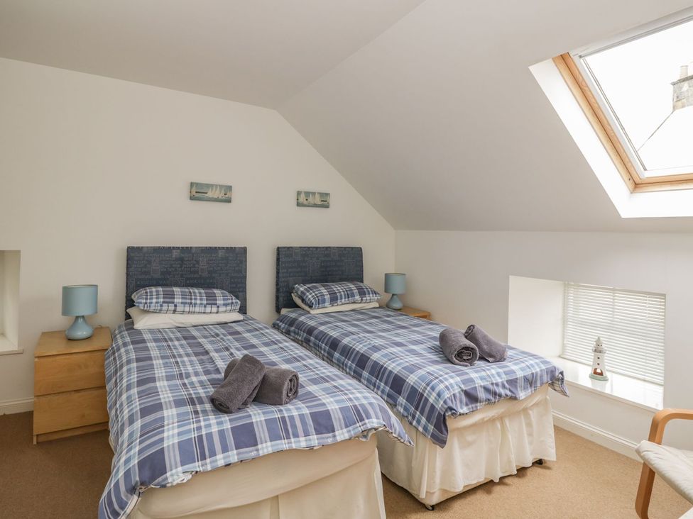 A bedroom with twin beds and a skylight at Flour Loft Anstruther