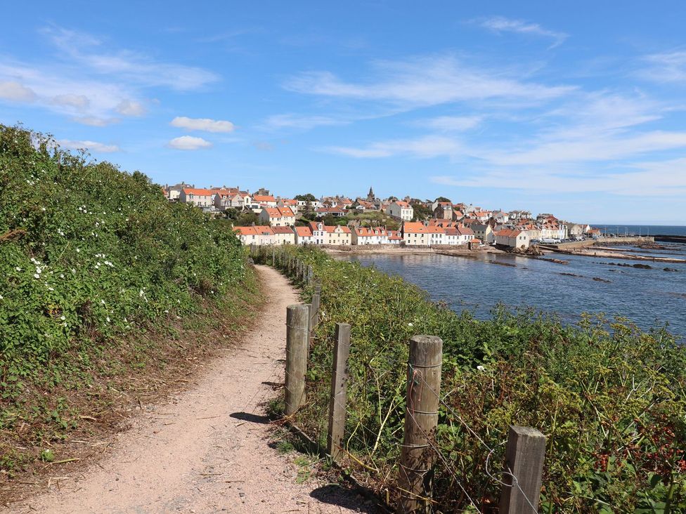 A coastal path with a view of houses by the water at Flour Loft Anstruther