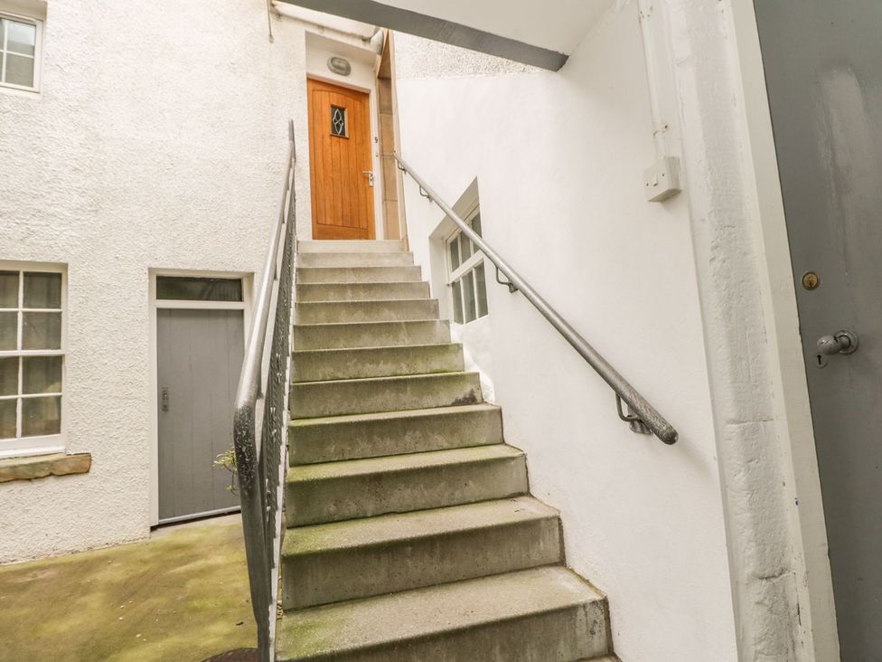 A staircase leading to a door at Hay Loft in Anstruther