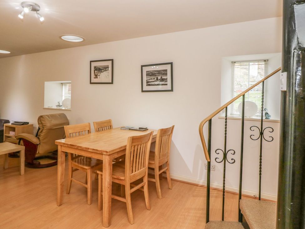 A dining room with a table and chairs at Hay Loft in Anstruther