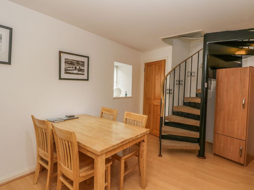 A dining room with a table and chairs at Hay Loft in Anstruther