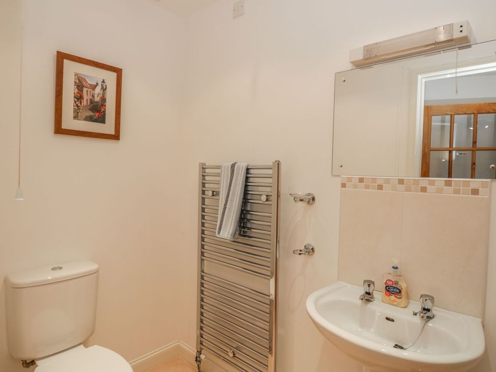 A bathroom with a toilet and hand basin at Hay Loft in Anstruther