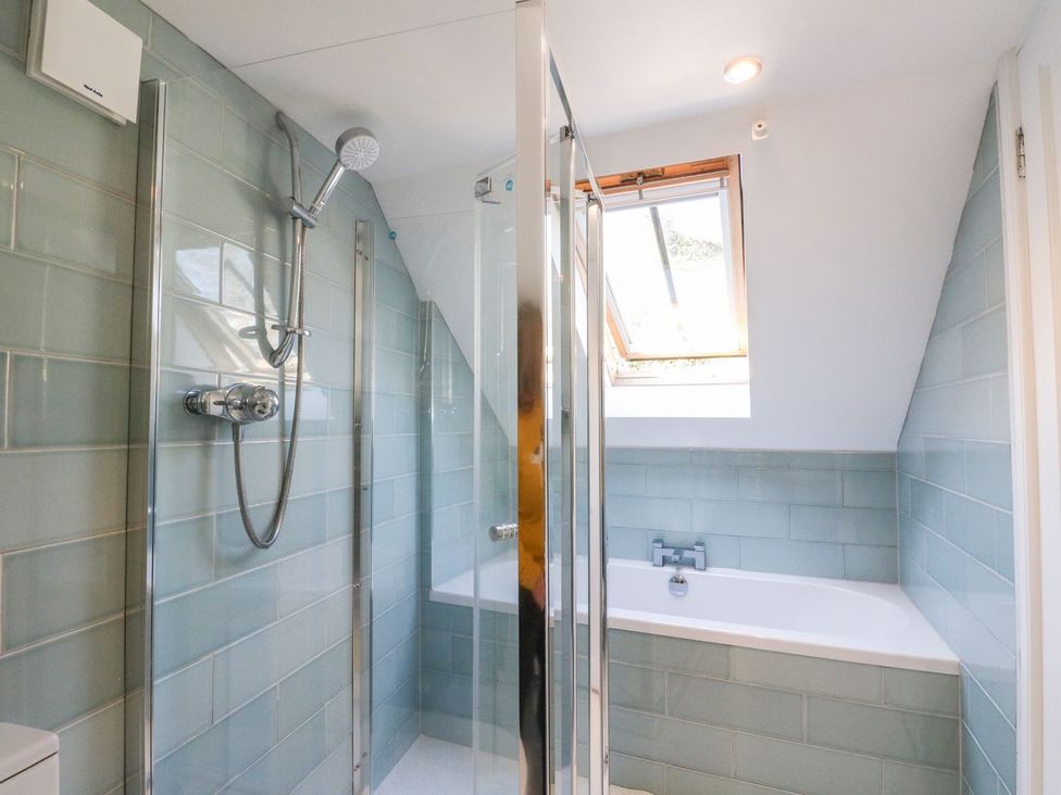 A bathroom with a shower and bathtub at Hay Loft in Anstruther